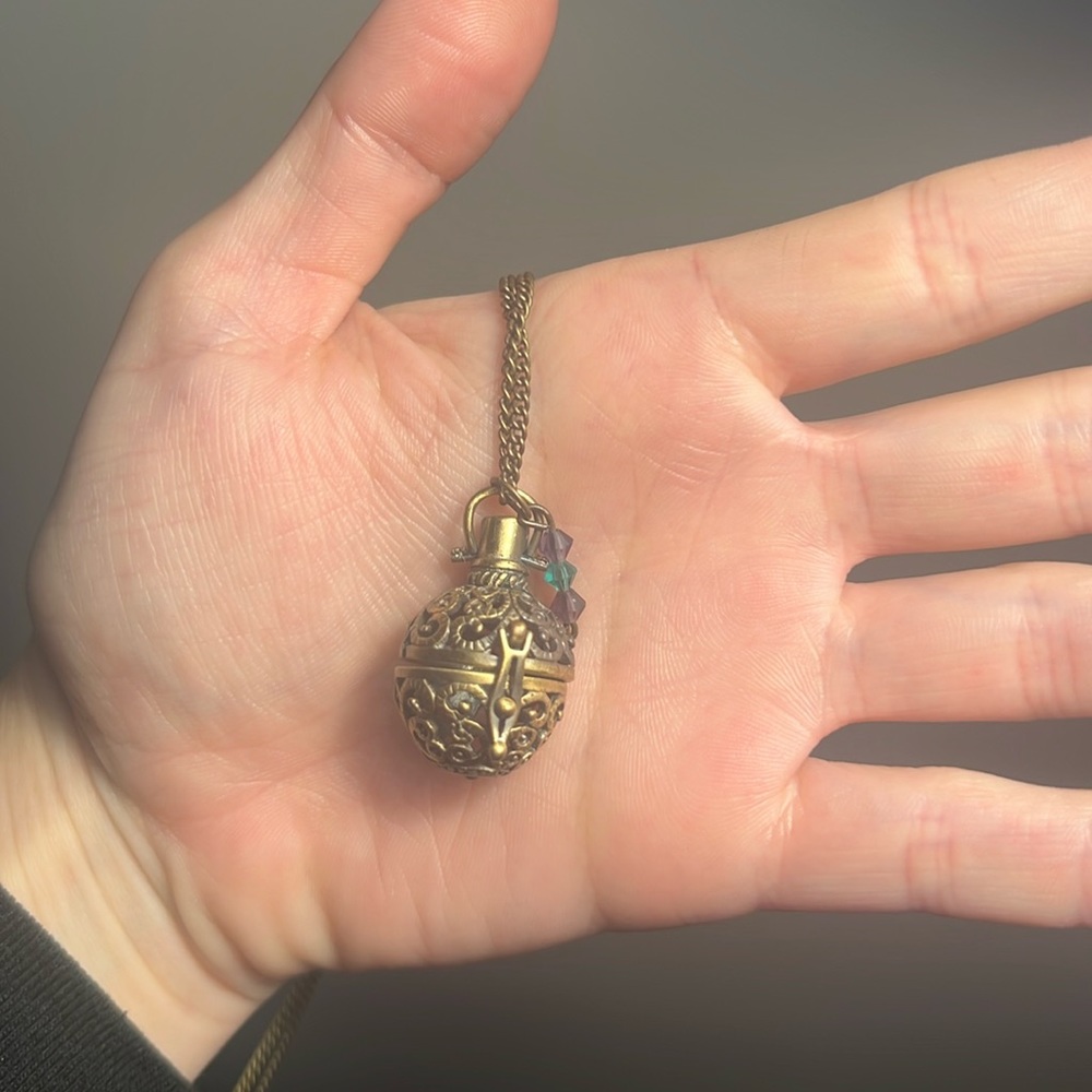 Gold tone diffuser locket necklace with teal and purple Swarovski crystals